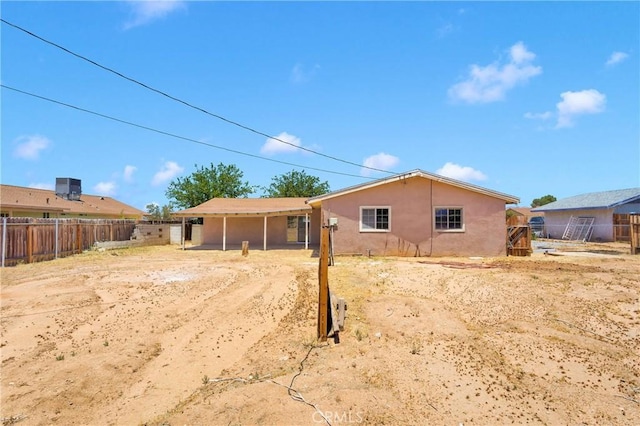 21815 Jelan Ave, Apple Valley, CA 92307 - rear view of house with stucco siding and a fenced backyard