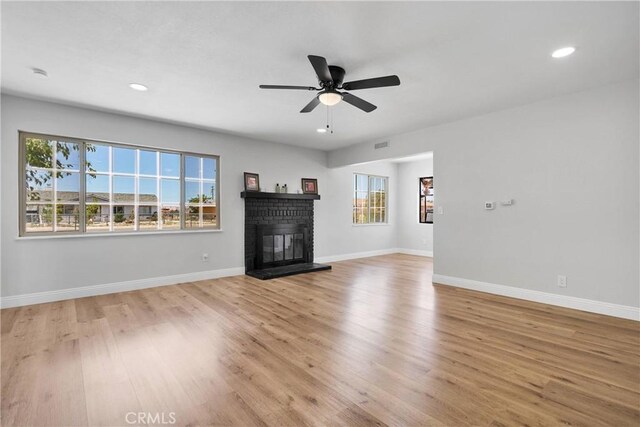 21815 Jelan Ave, Apple Valley, CA 92307 - unfurnished living room with wood finished floors, recessed lighting, a fireplace, and ceiling fan