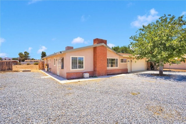 21815 Jelan Ave, Apple Valley, CA 92307 - view of front of house with a chimney, a garage, and stucco siding