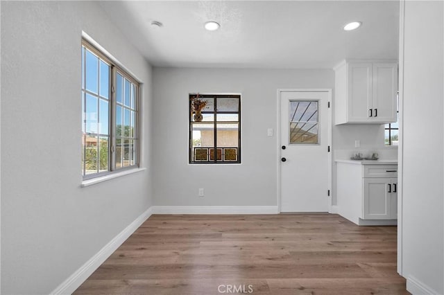 21815 Jelan Ave, Apple Valley, CA 92307 - unfurnished dining area with light wood-style flooring and recessed lighting