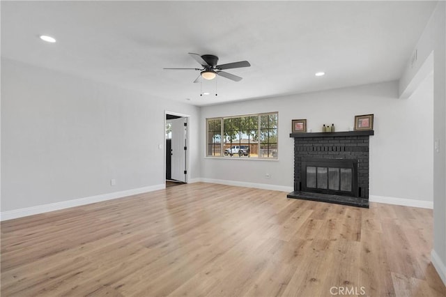 21815 Jelan Ave, Apple Valley, CA 92307 - unfurnished living room with light wood-style flooring, a ceiling fan, a fireplace, and recessed lighting