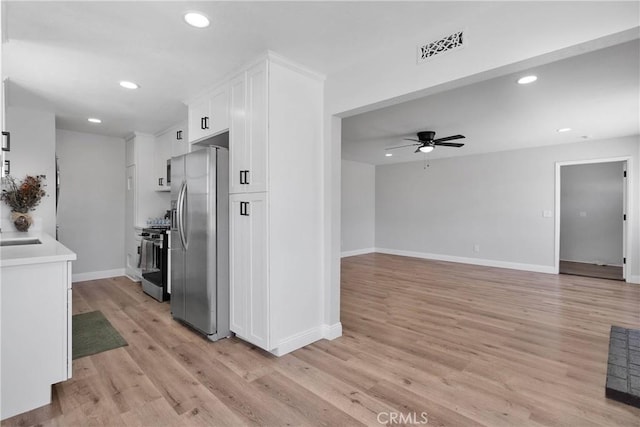 21815 Jelan Ave, Apple Valley, CA 92307 - kitchen featuring appliances with stainless steel finishes, white cabinetry, light wood finished floors, a ceiling fan, and recessed lighting