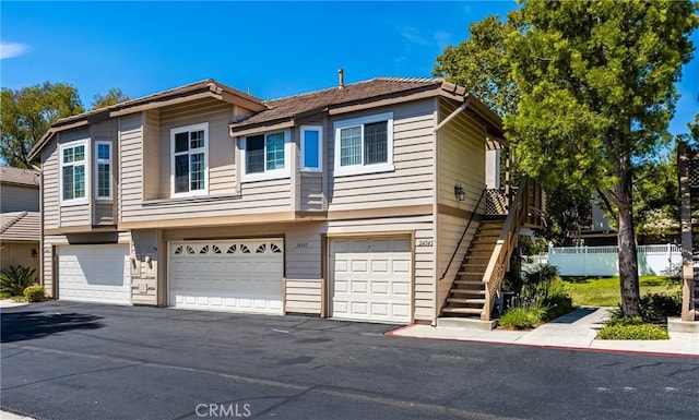 24343 Landover Rd Unit 139, Laguna Hills, CA 92653 - townhome / multi-family property featuring a garage, driveway, and stairs
