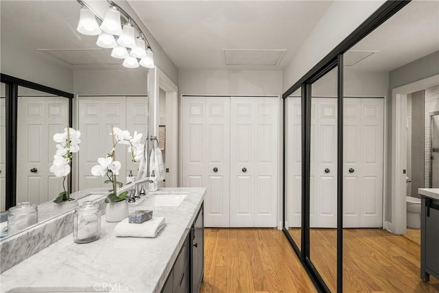 24343 Landover Rd Unit 139, Laguna Hills, CA 92653 - bathroom featuring a closet, vanity, and wood finished floors