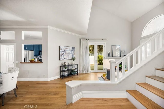 24343 Landover Rd Unit 139, Laguna Hills, CA 92653 - entryway featuring light wood-type flooring, stairway, high vaulted ceiling, and ornamental molding