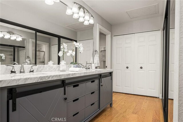 24343 Landover Rd Unit 139, Laguna Hills, CA 92653 - full bathroom featuring a closet, double vanity, wood finished floors, and a shower