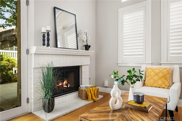 24343 Landover Rd Unit 139, Laguna Hills, CA 92653 - sitting room with a brick fireplace and wood finished floors