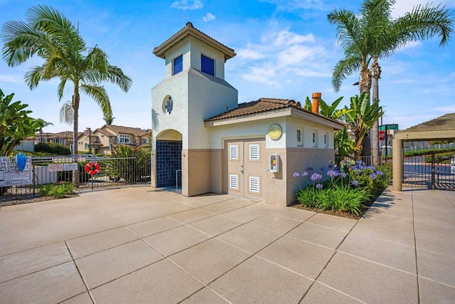 4625 Los Alamos Way Unit C, Oceanside, CA 92057 - view of front of house with stucco siding, a tile roof, and a gate