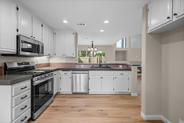 4625 Los Alamos Way Unit C, Oceanside, CA 92057 - kitchen featuring stainless steel appliances, dark countertops, white cabinetry, and recessed lighting