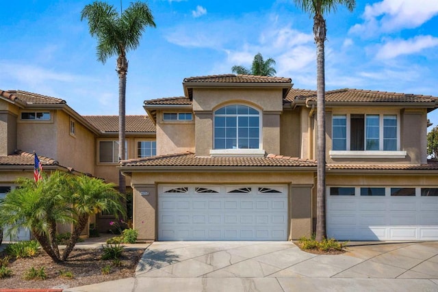 4625 Los Alamos Way Unit C, Oceanside, CA 92057 - view of front of property featuring concrete driveway, a garage, a tiled roof, and stucco siding