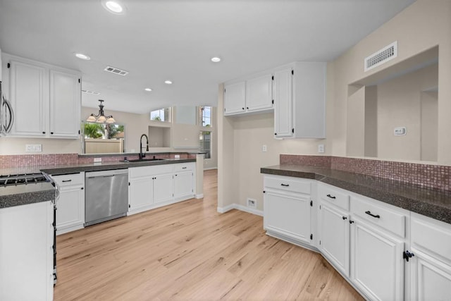 4625 Los Alamos Way Unit C, Oceanside, CA 92057 - kitchen featuring stainless steel appliances, white cabinets, dark countertops, light wood-style floors, and recessed lighting