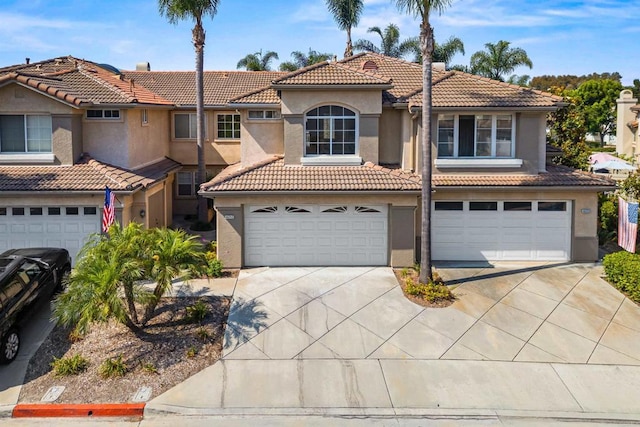 4625 Los Alamos Way Unit C, Oceanside, CA 92057 - mediterranean / spanish-style home with driveway, stucco siding, a tile roof, and a garage