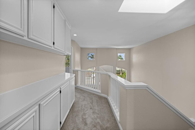 4625 Los Alamos Way Unit C, Oceanside, CA 92057 - hallway featuring an upstairs landing, light colored carpet, a skylight, and recessed lighting
