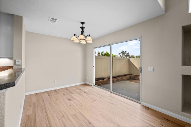 4625 Los Alamos Way Unit C, Oceanside, CA 92057 - unfurnished dining area with a chandelier and wood finished floors
