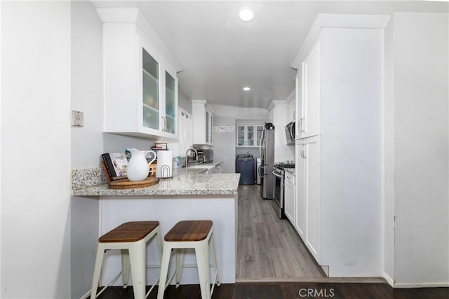5082 La Madera Ave, El Monte, CA 91732 - kitchen with appliances with stainless steel finishes, white cabinets, glass insert cabinets, a breakfast bar area, and recessed lighting