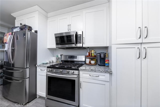 5082 La Madera Ave, El Monte, CA 91732 - kitchen with stainless steel appliances, light stone countertops, and white cabinetry