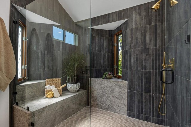 602 Sereno View Rd, Encinitas, CA 92024 - full bathroom with a tile shower, tile walls, plenty of natural light, and lofted ceiling