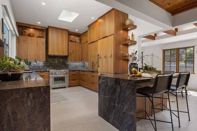 602 Sereno View Rd, Encinitas, CA 92024 - kitchen with stainless steel stove, open shelves, brown cabinetry, backsplash, and recessed lighting