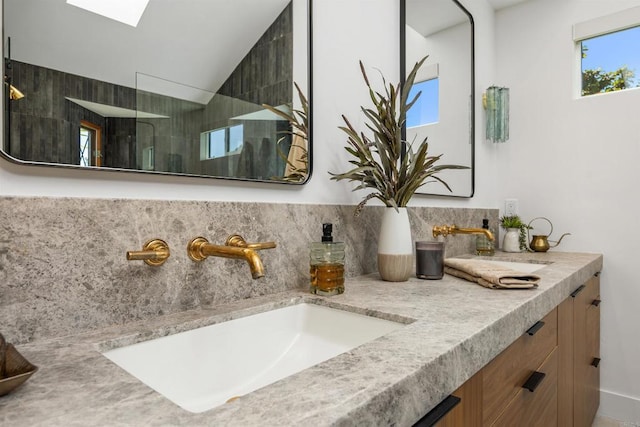 602 Sereno View Rd, Encinitas, CA 92024 - bathroom with double vanity, a walk in shower, vaulted ceiling, and a skylight