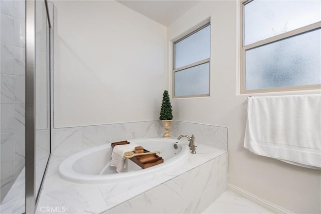 14217 Pemberley Passage Ave, Bakersfield, CA 93311 - bathroom featuring marble look tile flooring and a bath