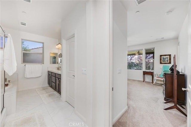 14217 Pemberley Passage Ave, Bakersfield, CA 93311 - hallway with baseboards and light marble finish flooring