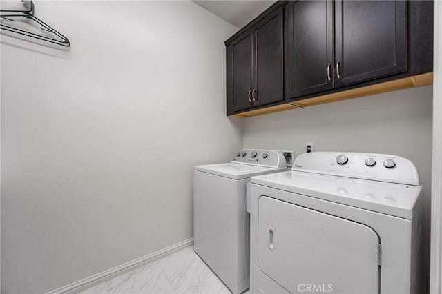 14217 Pemberley Passage Ave, Bakersfield, CA 93311 - laundry room featuring independent washer and dryer, cabinet space, and light marble finish floors