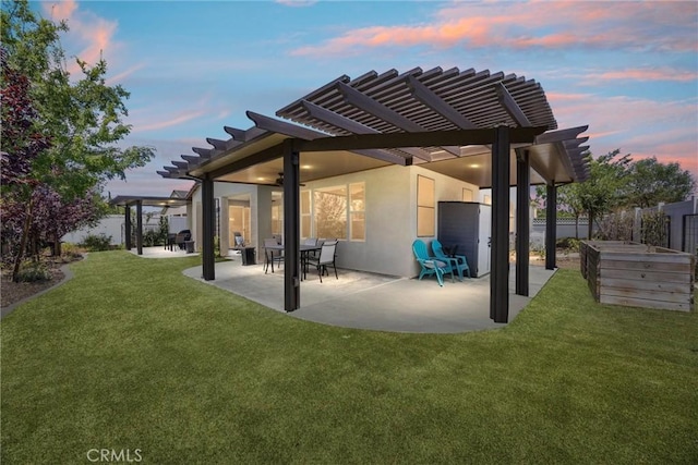 14217 Pemberley Passage Ave, Bakersfield, CA 93311 - back of house at dusk featuring a pergola, a patio, and stucco siding
