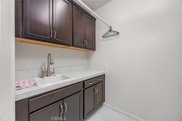 14217 Pemberley Passage Ave, Bakersfield, CA 93311 - laundry room with a sink and light marble finish flooring