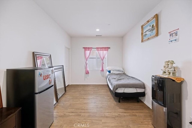 26947 Mountaingate St, Menifee, CA 92585 - bedroom with freestanding refrigerator, light wood-type flooring, and recessed lighting