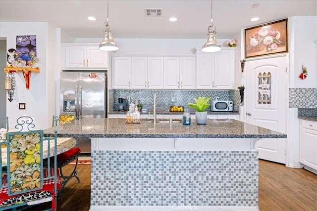 26947 Mountaingate St, Menifee, CA 92585 - kitchen featuring white cabinetry, stainless steel appliances, a kitchen breakfast bar, and recessed lighting
