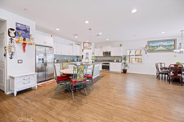 26947 Mountaingate St, Menifee, CA 92585 - dining room featuring light wood-type flooring, a chandelier, and recessed lighting