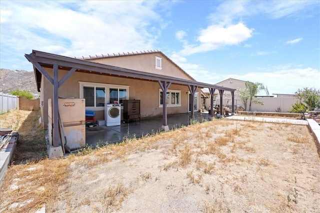 26947 Mountaingate St, Menifee, CA 92585 - rear view of property with washer / clothes dryer, stucco siding, a patio, and a fenced backyard