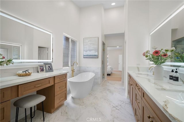 15 Lyon Rdg, Aliso Viejo, CA 92656 - ensuite bathroom with a towering ceiling, a freestanding bath, vanity, wainscoting, and tile walls