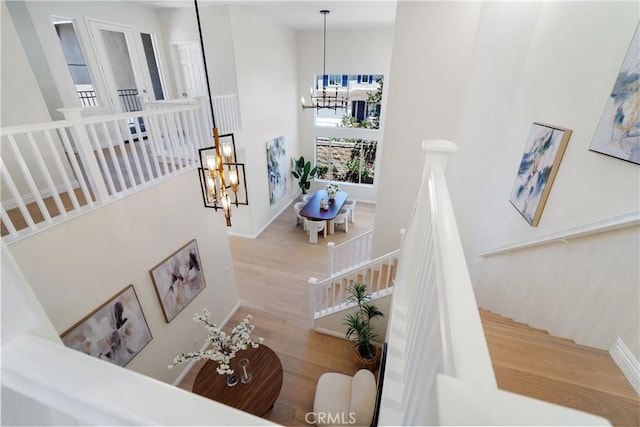 15 Lyon Rdg, Aliso Viejo, CA 92656 - stairs with a chandelier, wood finished floors, and a high ceiling