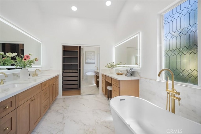 15 Lyon Rdg, Aliso Viejo, CA 92656 - full bath featuring double vanity, a freestanding tub, marble finish floors, and recessed lighting