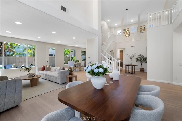 15 Lyon Rdg, Aliso Viejo, CA 92656 - dining area featuring light wood-type flooring, stairway, healthy amount of natural light, recessed lighting, and a towering ceiling