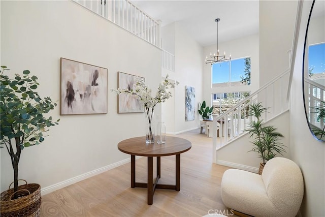 15 Lyon Rdg, Aliso Viejo, CA 92656 - sitting room featuring light wood-style flooring, a chandelier, a high ceiling, and stairs