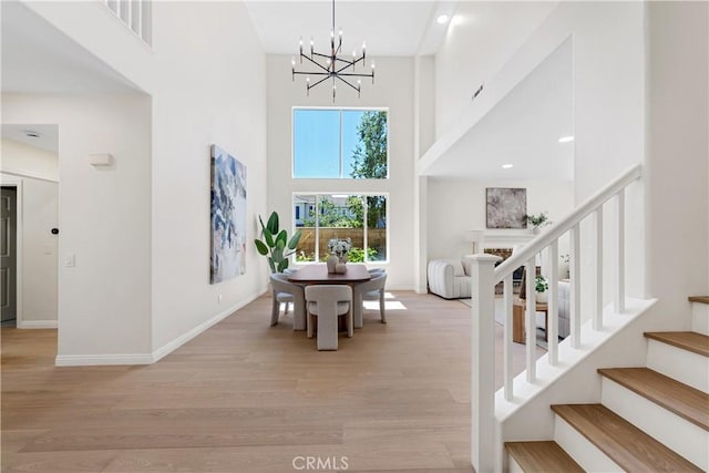 15 Lyon Rdg, Aliso Viejo, CA 92656 - foyer with a towering ceiling, a chandelier, stairs, and light wood finished floors