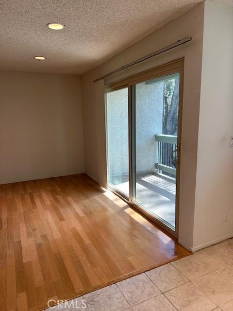 23675 Park Capri Unit 24, Calabasas, CA 91302 - spare room with a textured ceiling, light wood-type flooring, and recessed lighting