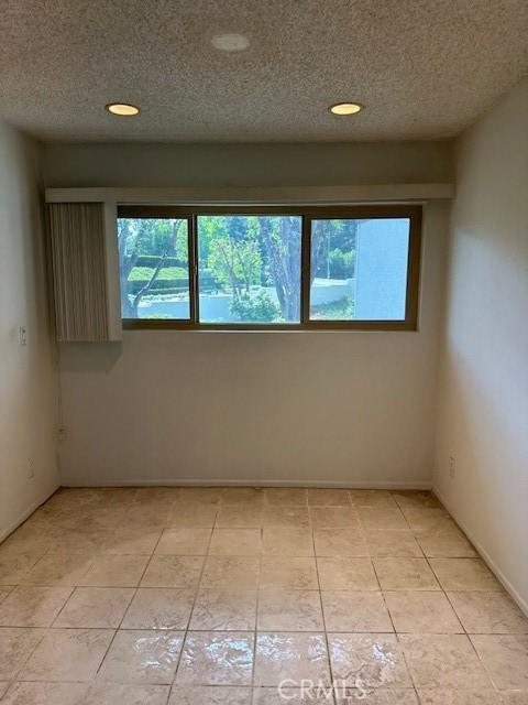 23675 Park Capri Unit 24, Calabasas, CA 91302 - unfurnished room featuring a textured ceiling and recessed lighting