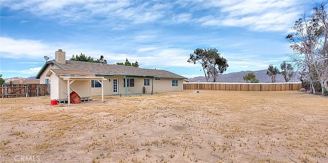 14158 Tu Su Cir, Apple Valley, CA 92307 - rear view of property with a fenced backyard, a chimney, and a mountain view