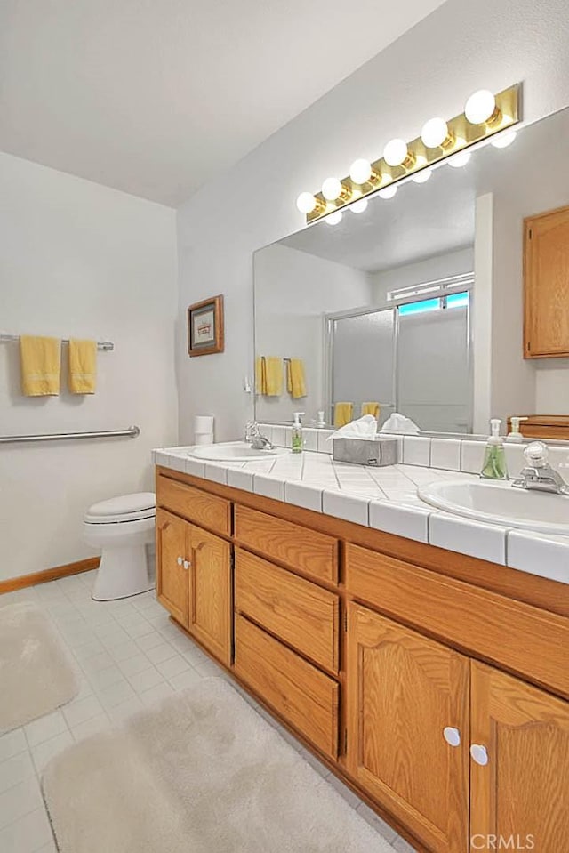 14158 Tu Su Cir, Apple Valley, CA 92307 - bathroom with double vanity, a shower with door, and tile patterned floors