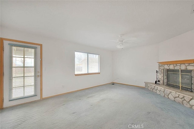14158 Tu Su Cir, Apple Valley, CA 92307 - unfurnished living room featuring plenty of natural light, carpet floors, a ceiling fan, and a stone fireplace