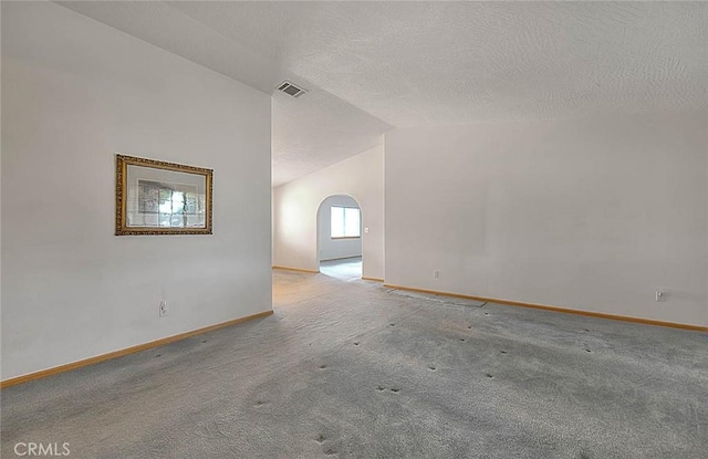 14158 Tu Su Cir, Apple Valley, CA 92307 - unfurnished room with carpet flooring, arched walkways, a textured ceiling, and lofted ceiling