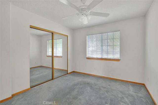 14158 Tu Su Cir, Apple Valley, CA 92307 - unfurnished bedroom featuring carpet flooring, a closet, a ceiling fan, and a textured ceiling