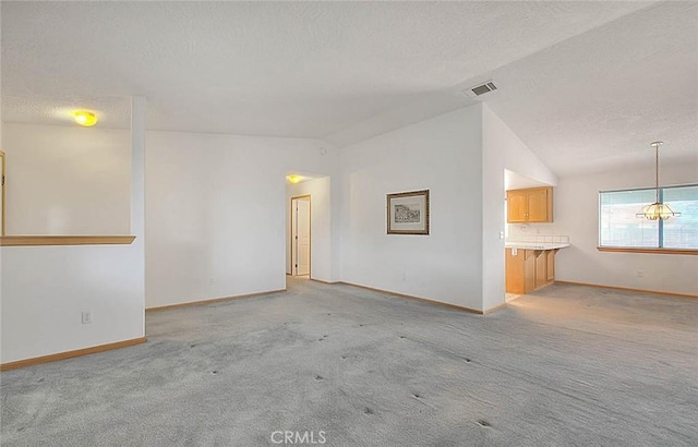 14158 Tu Su Cir, Apple Valley, CA 92307 - unfurnished living room with lofted ceiling, light colored carpet, and a textured ceiling
