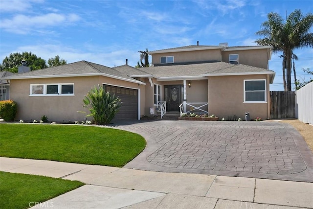 19536 Kittridge St, Reseda, CA 91335 - view of front of house featuring stucco siding, a garage, decorative driveway, and a shingled roof