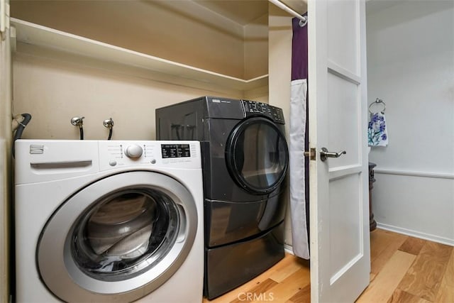 19536 Kittridge St, Reseda, CA 91335 - laundry area with washer and clothes dryer and light wood-type flooring
