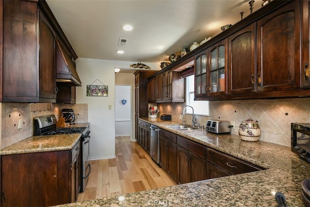 19536 Kittridge St, Reseda, CA 91335 - kitchen with appliances with stainless steel finishes, dark brown cabinetry, light stone countertops, light wood finished floors, and recessed lighting