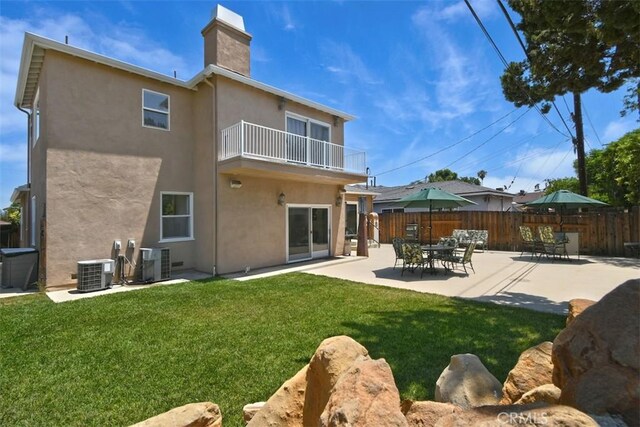 19536 Kittridge St, Reseda, CA 91335 - back of house featuring a balcony, stucco siding, a chimney, and a patio